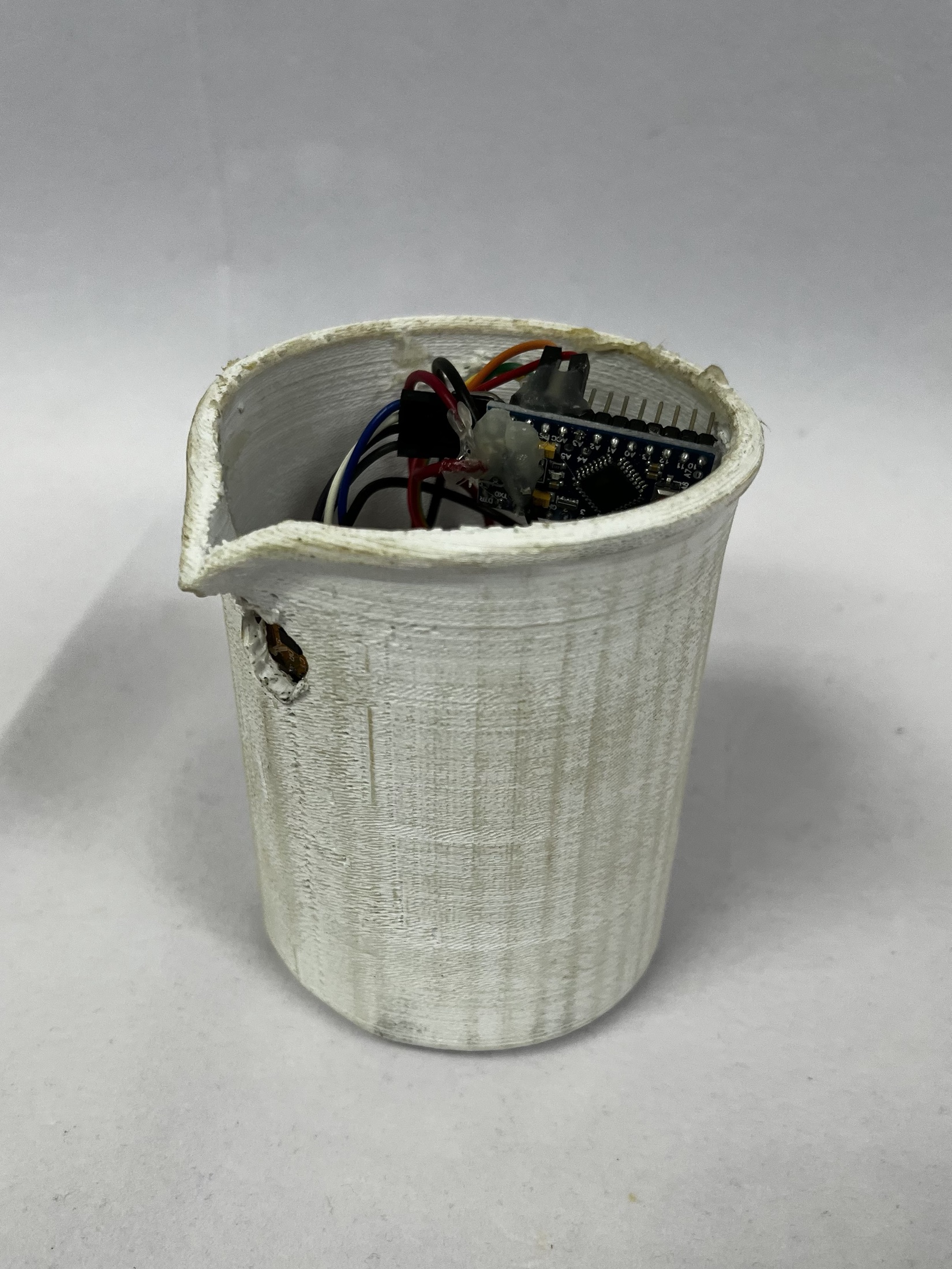 Close-up of the 3D-printed smart beaker and embedded electronics